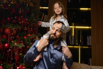 A happy family poses in pajamas in New Year's locations.