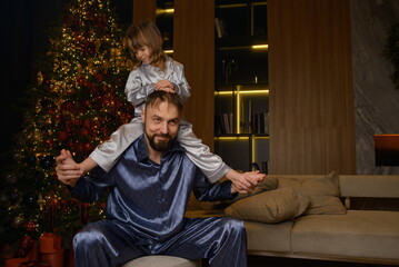A happy family poses in pajamas in New Year's locations.