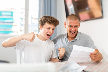 Father congratulates his son after reading a letter from college