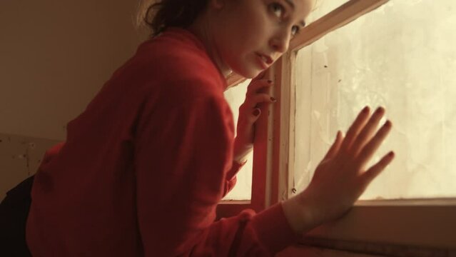 Woman doing interpretive dance at a window