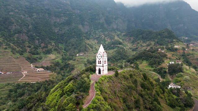 Establishing aerial view of Clock Tower Of Chapel of Our Lady of Fatima on Madeira island, Portugal