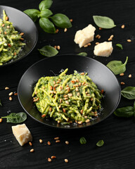 Trofie pasta with creamy spinach sauce and toasted pine nuts