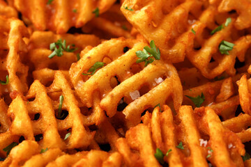 Crisscross potato lattices, golden waffle fries with sea salt and parsley