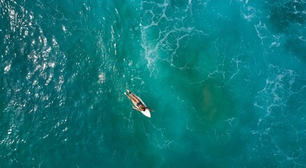 Fototapeta premium Aerial view of the ocean and surfer girl. Surfing in Midigama. Sri Lanka
