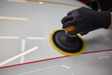 Person using machine to polish cars automotive exterior
