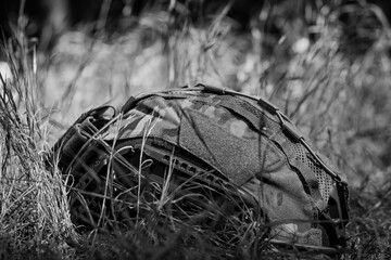 Tactical armored helmet with MultiCam color visor on the ground in the forest.
Military themes,...