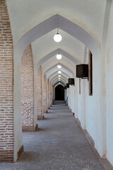 The corridor with columns and arches in the Grand Mosque of Yazd, Iran in full details.