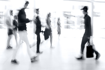 abstract image of people in the lobby of a modern business center with a blurred background