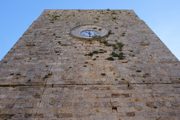 View of the Torre del Candeliere, a medieval tower with clock. Massa Marittima, Grosseto, Tuscany,...