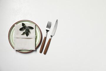 Stylish setting with elegant cutlery on white table, top view. Space for text