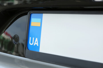Car with vehicle registration plate, closeup view