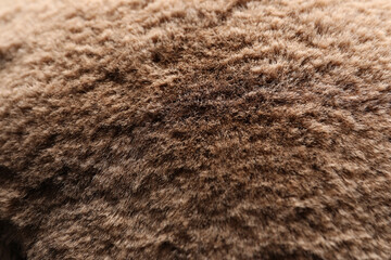 Texture of brown faux fur as background, closeup