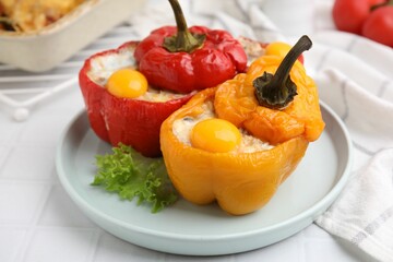 Delicious stuffed bell peppers with fried eggs on white table