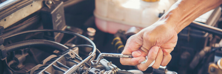 Banner Mechanic man hands repairing car shop. Man hands fixing Car machinery vehicle mechanical...