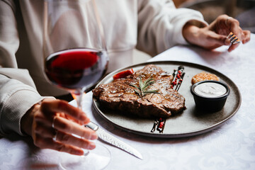 Beef steak served with red wine for dinner at a restaurant.
