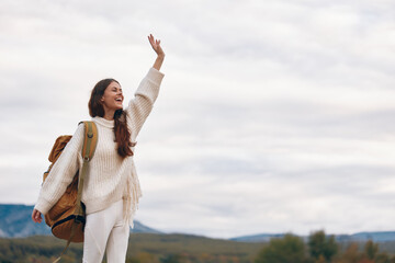 Mountain Adventure: Smiling Woman Enjoying Outdoor Cliff Hiking in Springtime