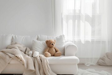 Scandinavian hygge interior design of modern white living room, white sofa with teddy bear home. Clear light through window.