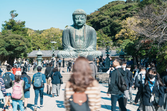 Woman tourist Visiting in Kamakura, Kanagawa, Japan. happy Traveler sightseeing the Great Buddha statue. Landmark and popular for tourists attraction near Tokyo. Travel and Vacation concept