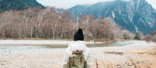 Woman tourist travel Kamikochi National Park, happy Traveler sightseeing Azusa river with mountain,...