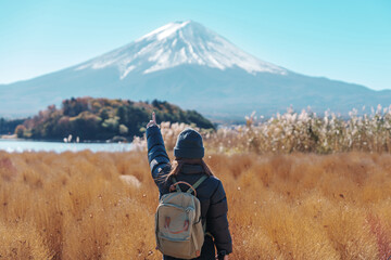 Woman tourist with Fuji Mountain at Lake Kawaguchi, happy Traveler sightseeing Mount Fuji in...