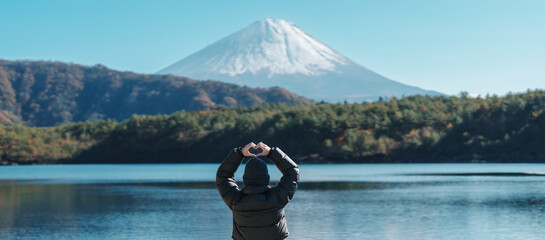 Woman tourist enjoy with Fuji Mountain at Lake Saiko, happy Traveler sightseeing Mount Fuji and road trip Fuji Five Lakes. Landmark for tourists attraction. Japan Travel, Destination and Vacation