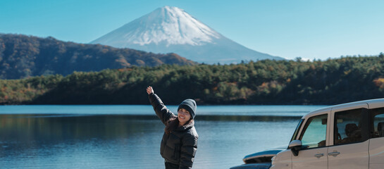 Woman tourist enjoy with Fuji Mountain at Lake Saiko, happy Traveler sightseeing Mount Fuji and...