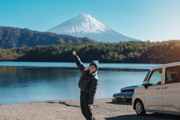 Woman tourist enjoy with Fuji Mountain at Lake Saiko, happy Traveler sightseeing Mount Fuji and...