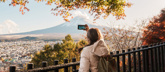 Woman tourist with mount Fuji at Chureito Pagoda in Autumn season, Traveler travel Arakurayama Sengen Park, Yamanashi, Japan. Landmark for tourist attraction. Japan Travel, Destination and Vacation