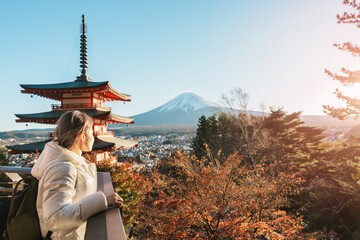 Woman tourist with mount Fuji at Chureito Pagoda in Autumn season, Traveler travel Arakurayama Sengen Park, Yamanashi, Japan. Landmark for tourist attraction. Japan Travel, Destination and Vacation © Jo Panuwat D