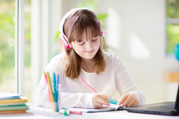 Online remote learning. School kids with computer.