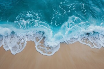 Turquoise ocean waves crash on the sandy beach.