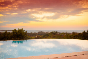 Swimming pool at sunset. Tropical vacation.