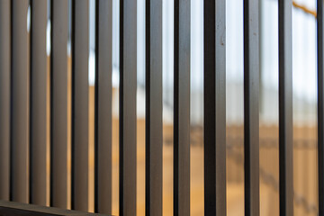 Close-up photo of a modern gray metal railing and concrete stair case between floors. 
