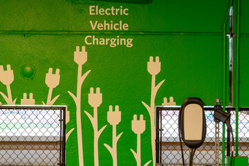 Close-up of electrical vehicle charging stations within a new concrete parking garage.