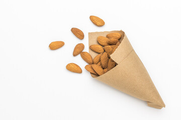 A paper bag with almonds on a white background.
