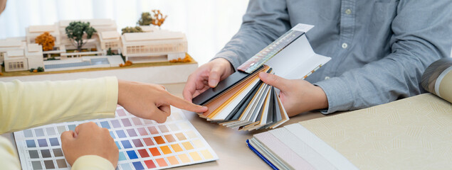 Interior designer team present color selection to project manager with color swatches and...