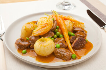 Stew - Lamb with  turnips, carrots, potatoes, onions and peas, in a thick glossy sauce.