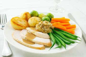 Roast Chicken Dinner - Roast chicken with roast potatoes, brussels sprouts, carrots, green beans, stuffing and gravy.