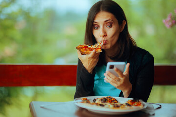 Woman Eating a Pizza while Checking her Phone. Girl being chronically online from fear of missing...