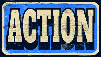 Aged and worn action sign on wood