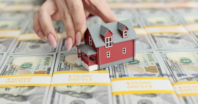 Realtor agent puts house on stack of 100 bills