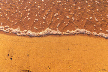 Soft wave of the sea on the sandy beach.