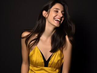 Fototapeta premium A woman in a yellow dress is smiling and laughing