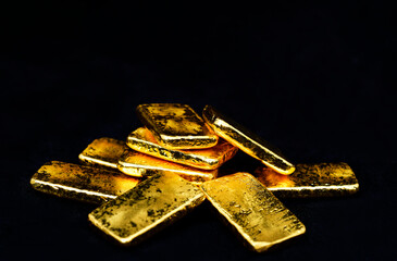 Close up photo a gold bars on black background, copy space