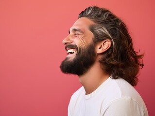 Fototapeta premium A man with a beard and long hair is smiling and laughing