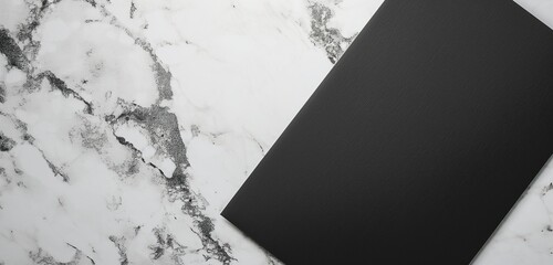 A panoramic view of a minimalist, matte black invitation card, its edges adorned with a subtle, silver foil design, set against a sleek, marble surface for a modern, sophisticated announcement. 
