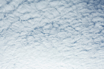 The sky has beautiful white, scaly clouds.