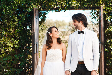 Happy couple, wedding and holding hands with love by entrance for marriage, support or trust in...