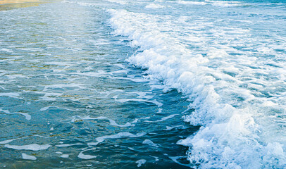 The blue sea with white waves 
