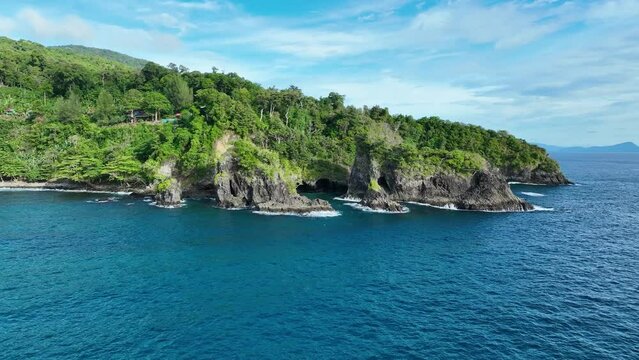 Deep blue ocean water, blue sky, picturesque coastal scenery, aerial